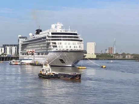 A cruise ship and tug mooring at London International Cruise ship terminal